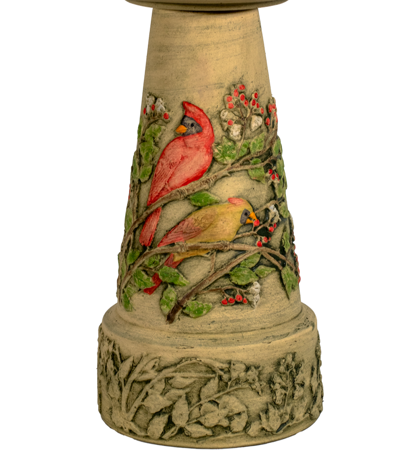 Decorative bird bath with cardinals on a white background