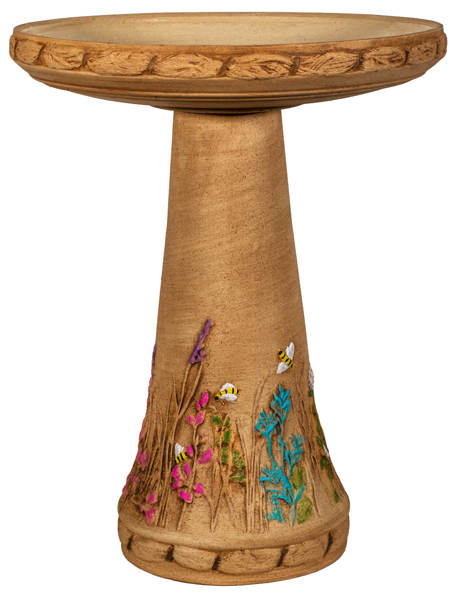 Decorative bird bath with floral and bee designs on a white background