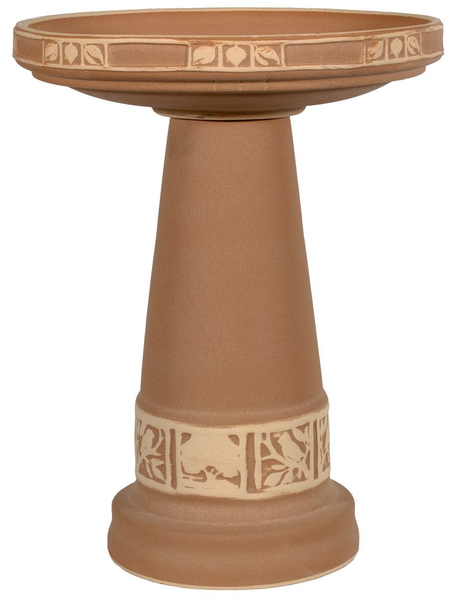 Terracotta-colored bird bath with decorative patterns on a white background