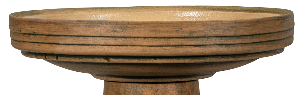 Decorative bird bath with natural elements on a white background