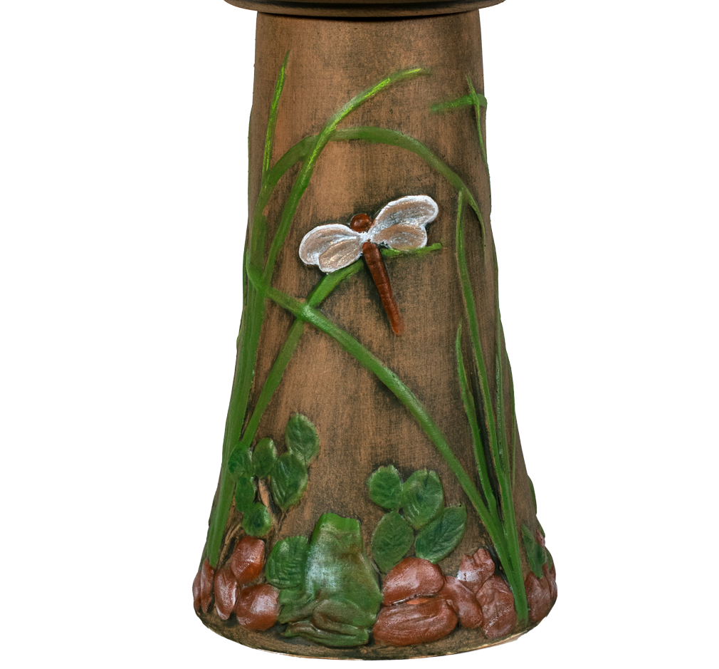 Decorative bird bath with a dragonfly design on a white background