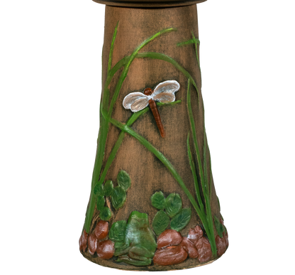 Decorative bird bath with a dragonfly design on a white background