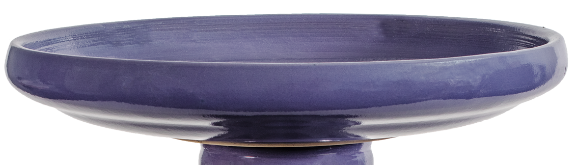 Purple ceramic bird bath on a white background