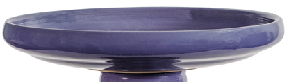 Purple ceramic bird bath on a white background