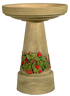 Decorative bird bath with strawberry patch design on a white background