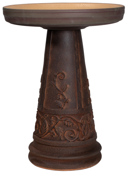 Decorative brown pedestal table with intricate iron works designs on a white background