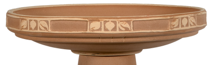 Terracotta-colored bird bath with decorative patterns on a white background