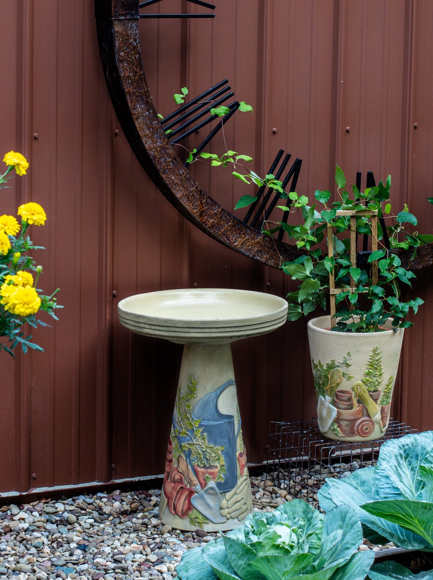 ceramic birdbath set with hand painted garden Tools and planter in landscaped garden area