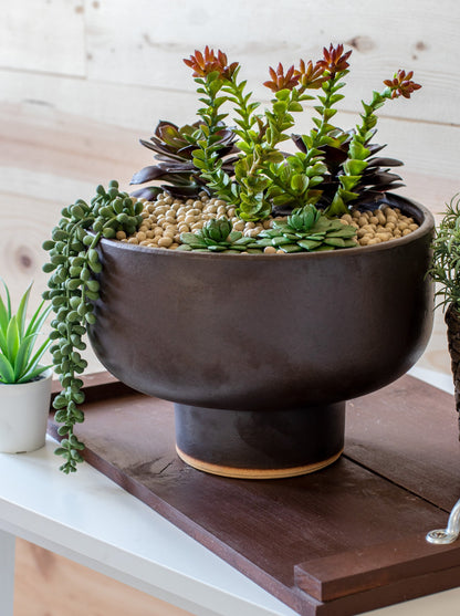 large ceramic brown planter with built in pedestal on wooden serving tray and succulents