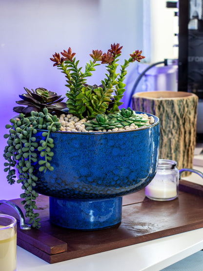 large ceramic blue spotted planter with built in pedestal on serving tray and candles