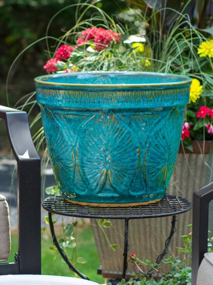 Large outdoor patio planter in turquoise glaze with leaf design on table top