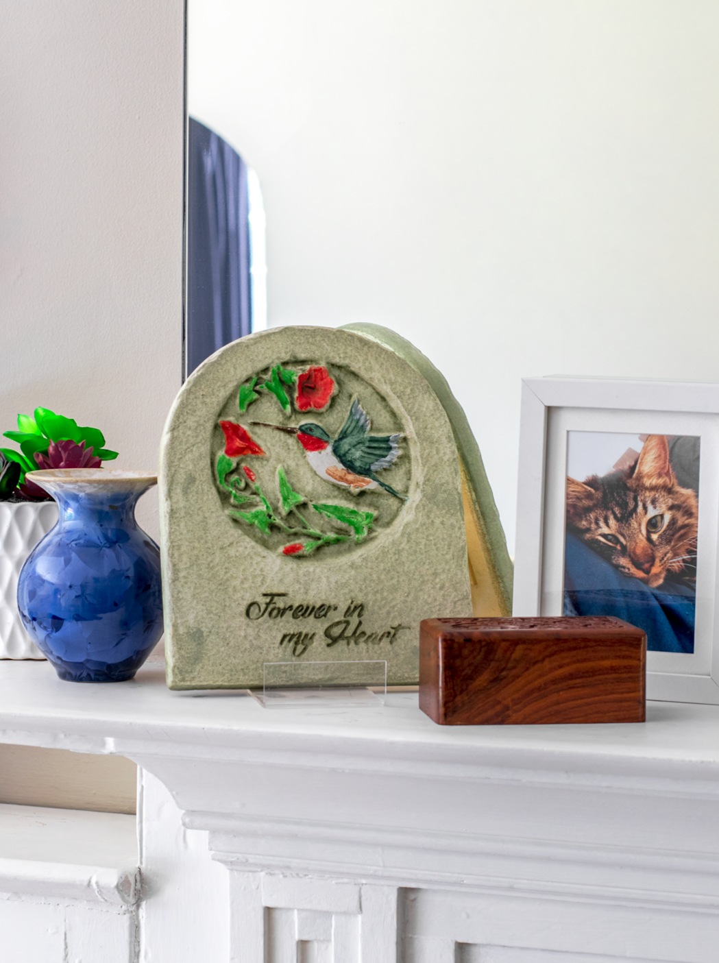 Ceramic hand painted plaque on a mantel with hummingbird and flower design for memorial