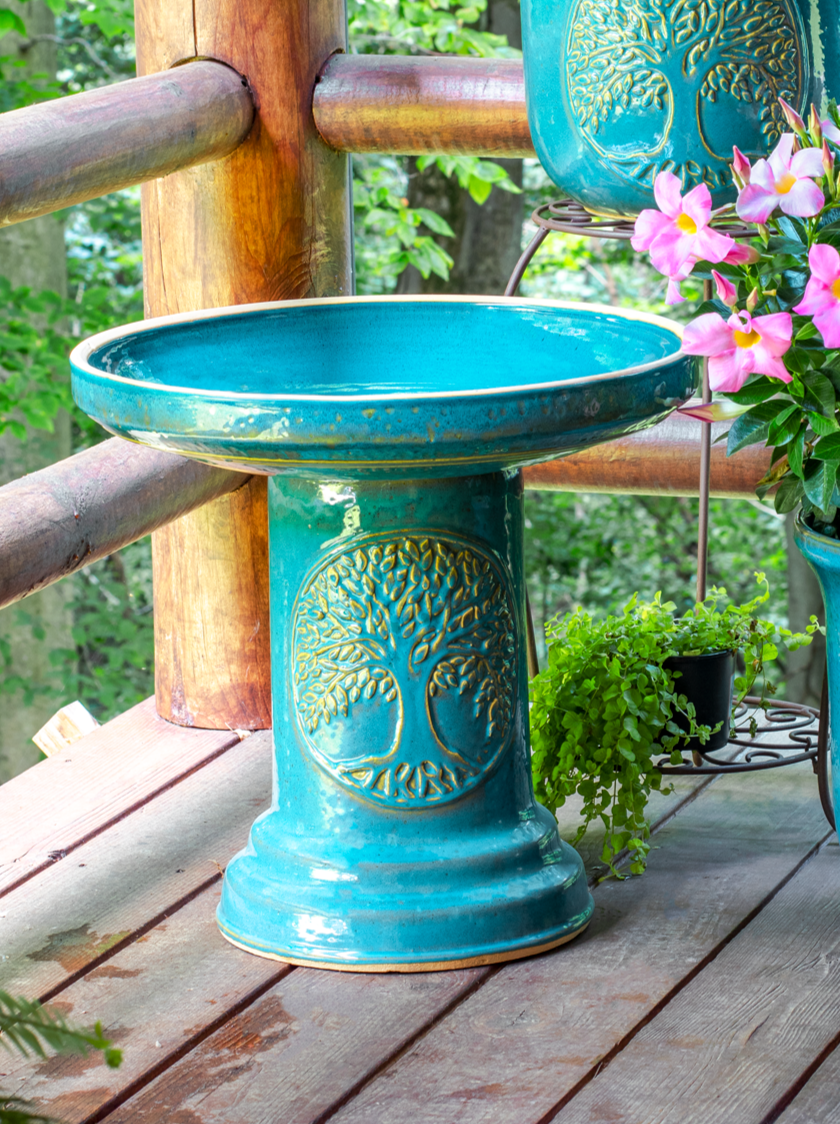 ceramic Turquoise birdbath set with Tree of Life motif on front porch
