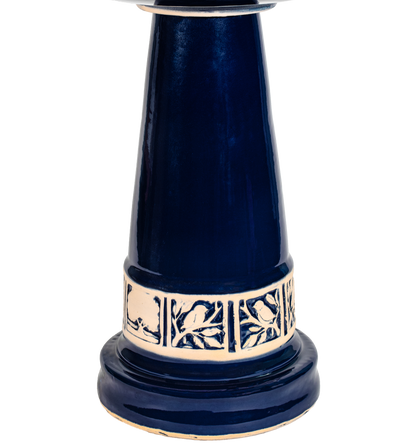 Ceramic blue birdbath pedestal with tan tree leaf and bird design 